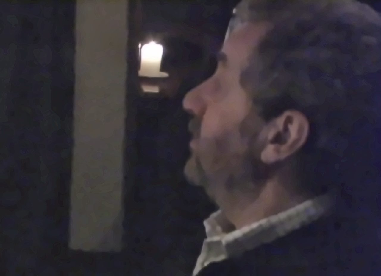 Still from Restaurants Are Not Democracies: a man in profile by candlelight